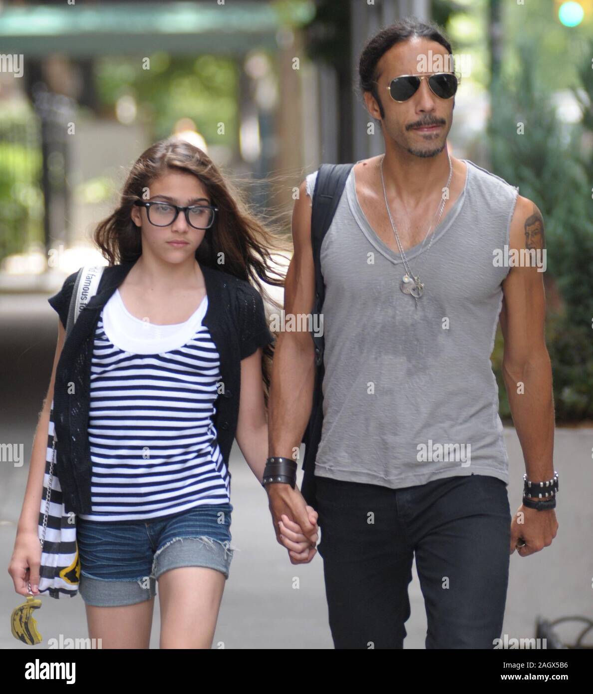 NEW YORK - JUNE 30:  Carlos Leon arrives at Madonna's Apt by bicycle to pick up their daughter Lourdes Maria Ciccone Leon (b. 14-Oct-1996 with Leon) just before husband Guy Richie is due to land in New York. Guy is eligibly flying in to town to talk to Madonna about saving their marriage. On June 30, 2008 in New York City  People:  Carlos Leon, Lourdes Maria Ciccone Leon Stock Photo