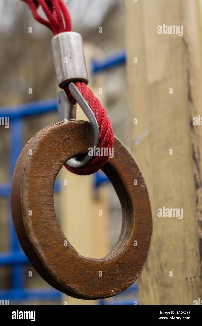 Gymnastic ring on the playground outdoors. Closeup of a wooden