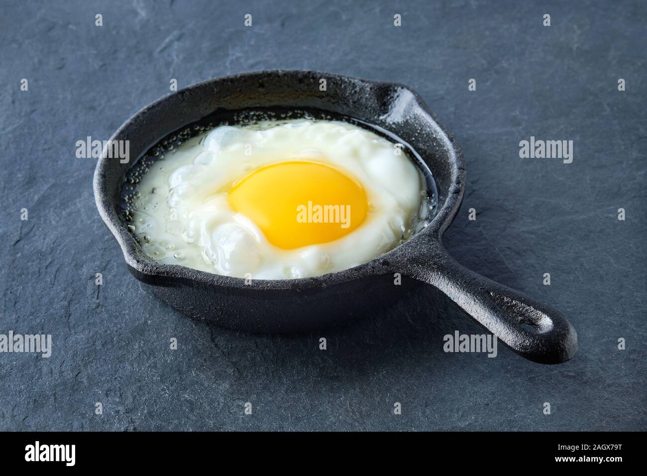 Scrambled egg in small castiron skillet. Making omelet eggs Stock