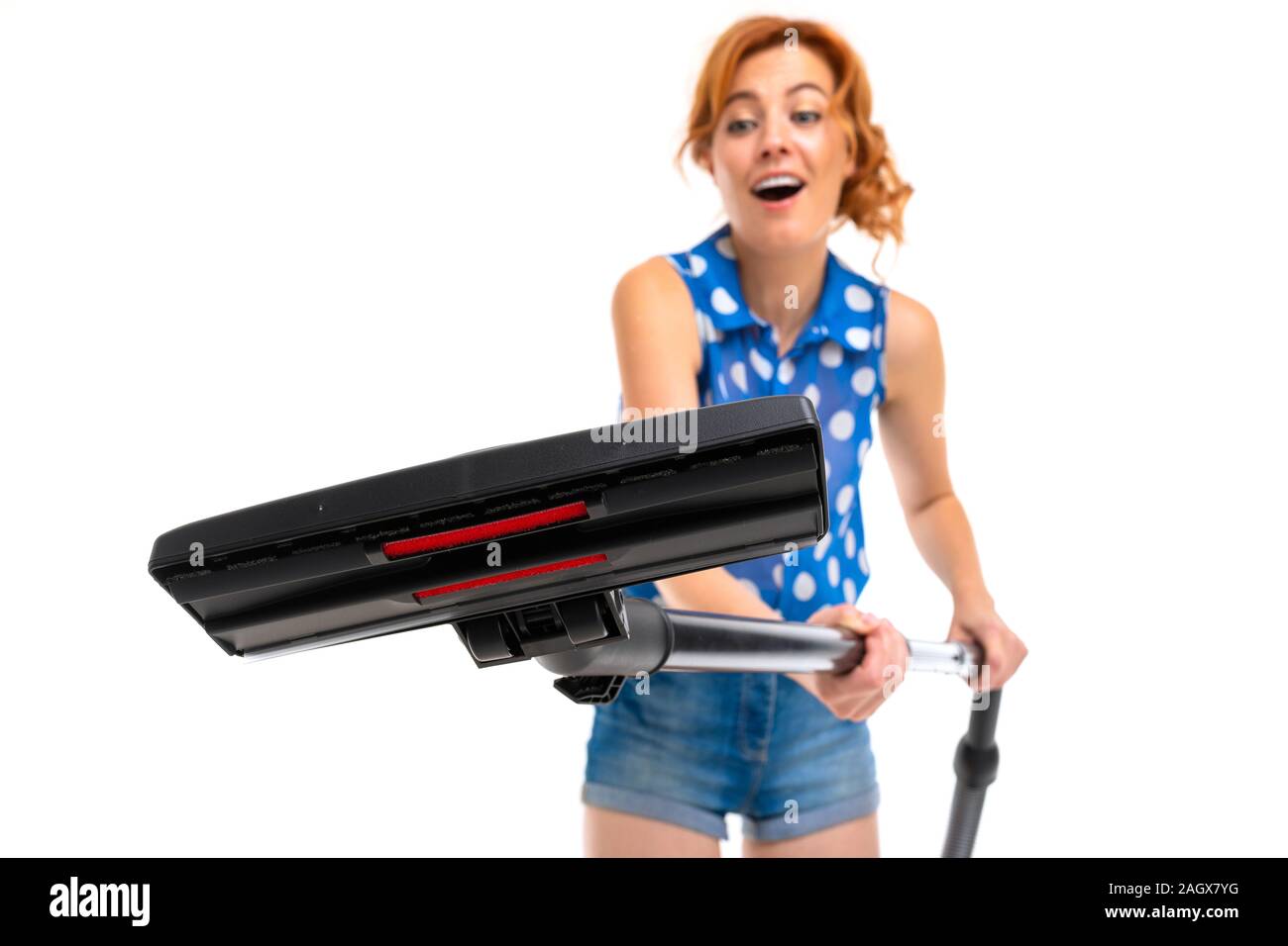 European girl with a vacuum cleaner in hands on a white background Stock Photo Alamy
