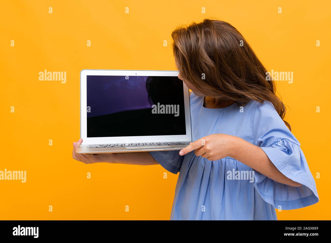 Download Girl Looking At Laptop Display With Mockup On Yellow Background Stock Photo Alamy PSD Mockup Templates