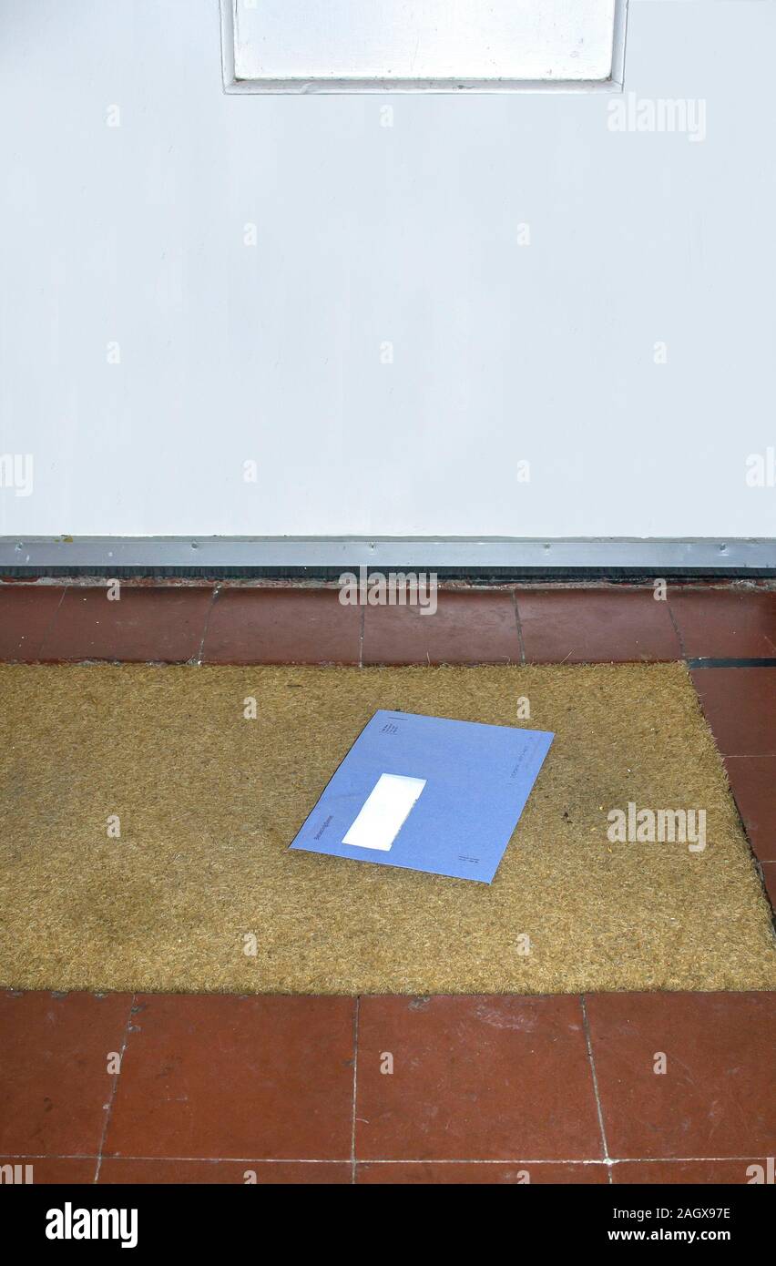 Blue envelope from the Dutch tax office on the doormat Stock Photo