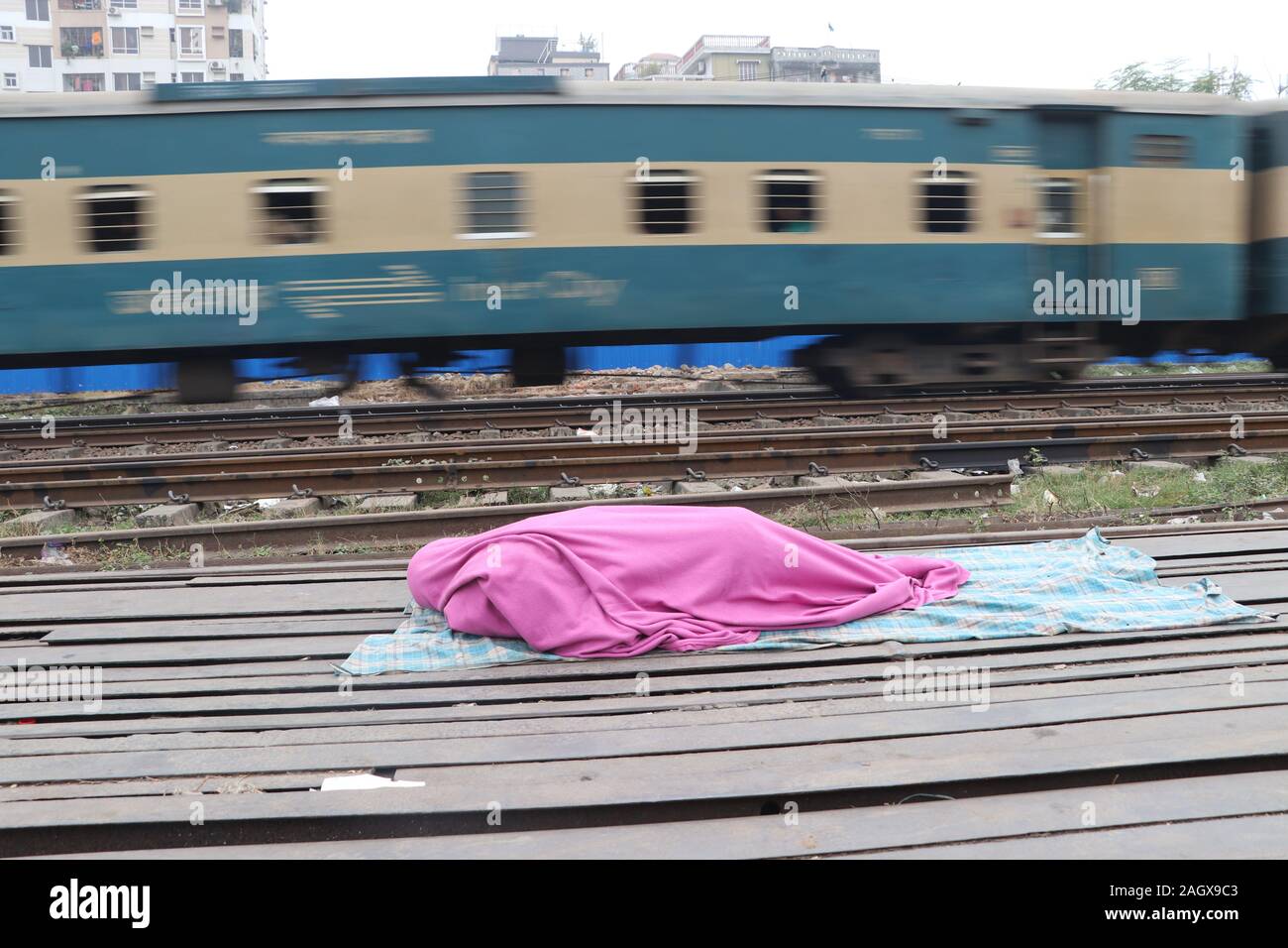 A Bangladeshi homeless people taking a nap on therail way station at Tajgoan in Dhaka, Bangladesh. Contributor: Nazmul Islam  / Alamy Stock Photo Stock Photo