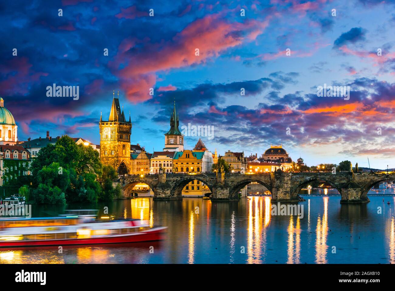View of dowtown Prague with Charles Bridge over the Vltava river after sunset. Czech Republic Stock Photo