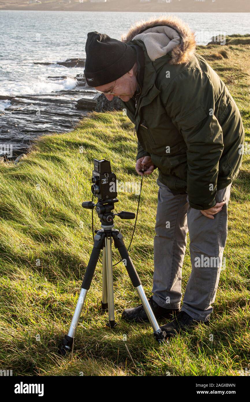 Older man photographing with Twin Lens camera Stock Photo