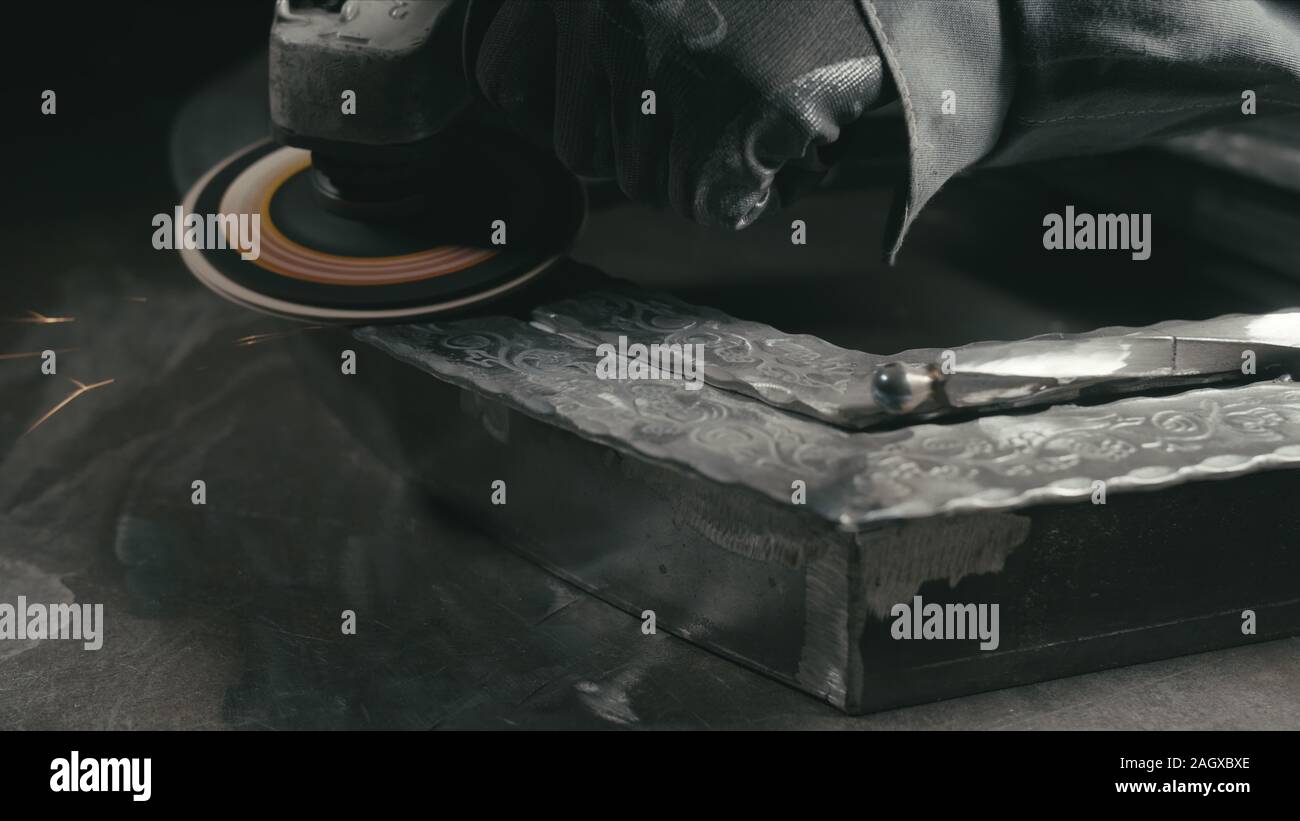 Smithy manual production. Polish metal with an angle grinder with an abrasive