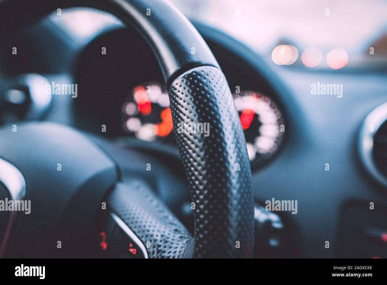 Close up shot of a steering wheel and speedometer in a car. Car