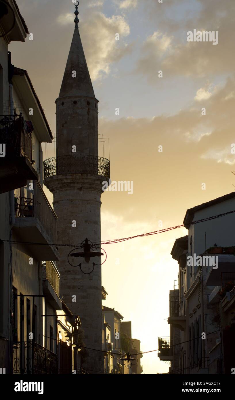 Minaret of old mosque in evening sun. Located at historic town of Chania in Crete, Greece Stock Photo