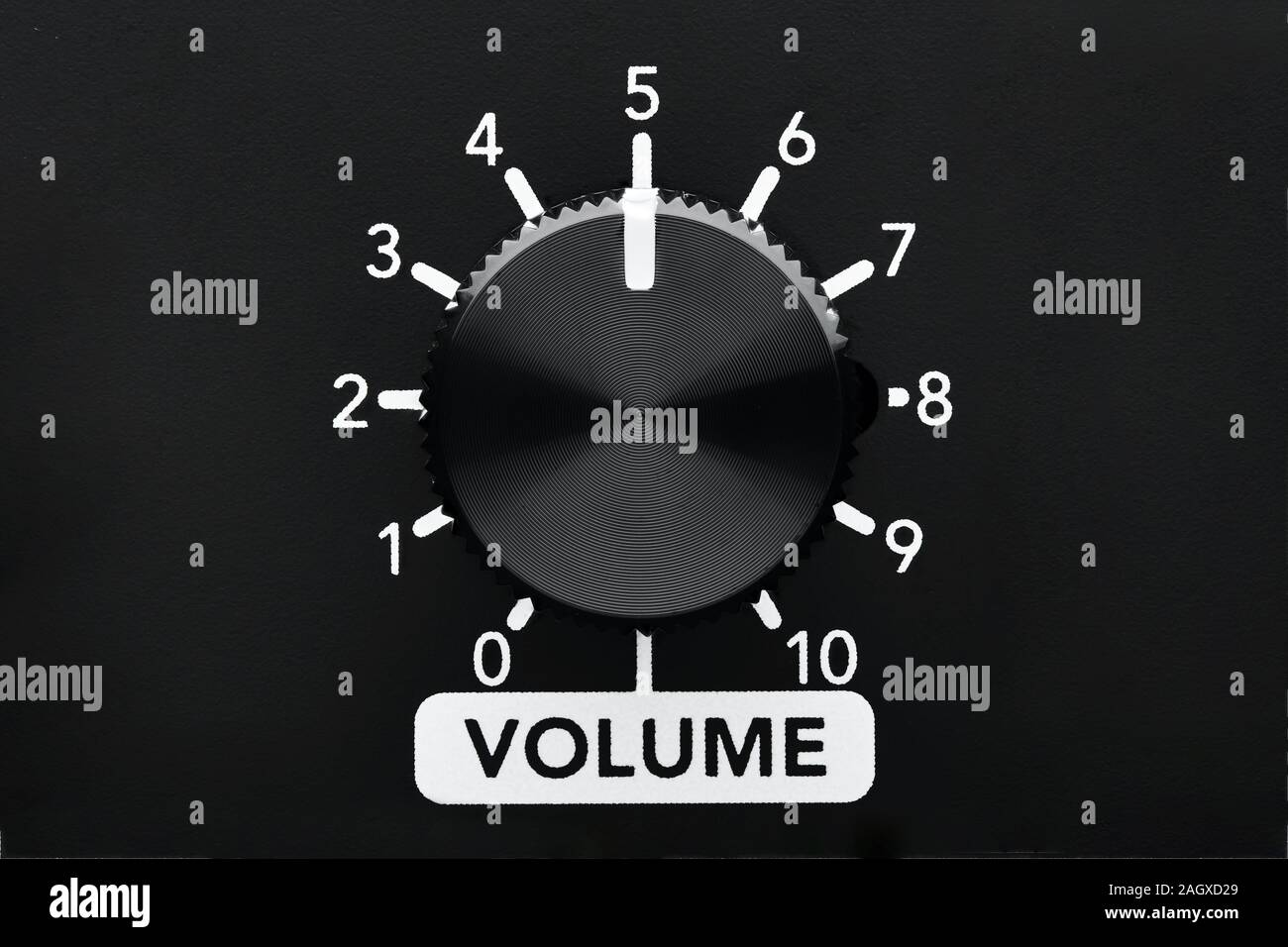 Volume control knob of a black amplifier with dial numbers. Close up