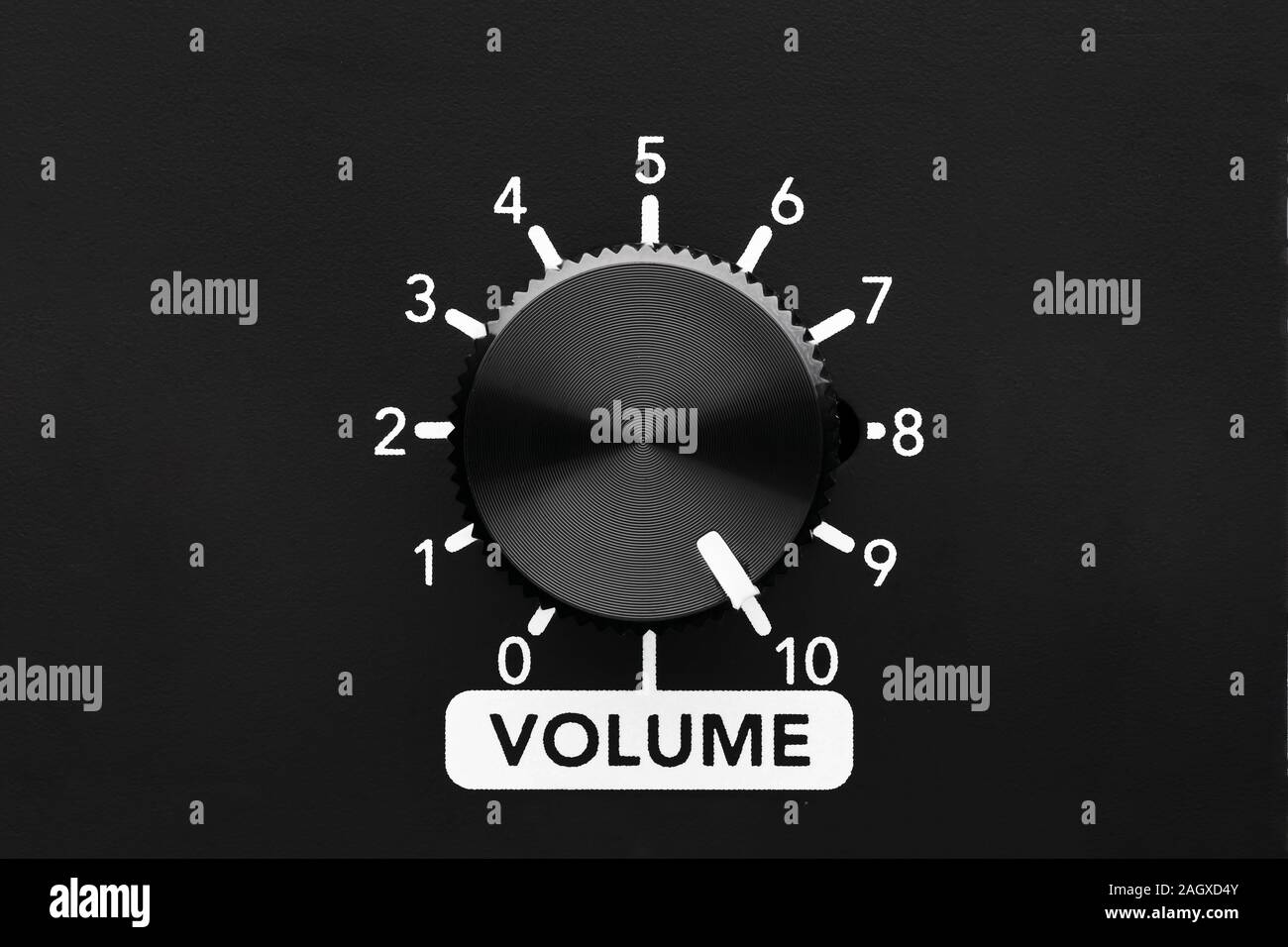 Volume control knob of a black amplifier on maximum loudness. Close up view with copy space. Stock Photo