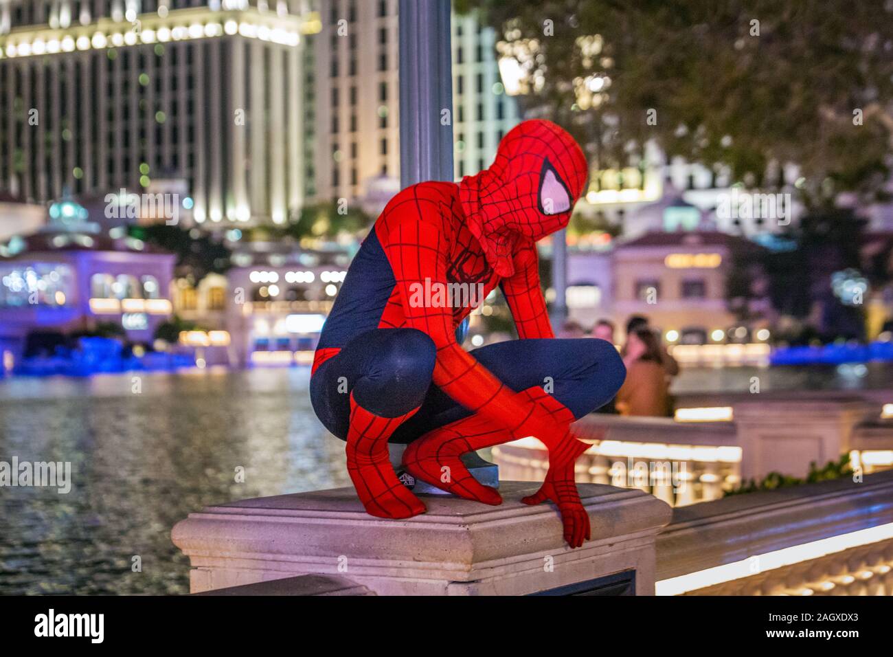 LAS VEGAS - JANUARY 24, 2018: Spiderman near fountains of Bellagio have been featured in several movies, is a large dancing water fountain synchronize Stock Photo