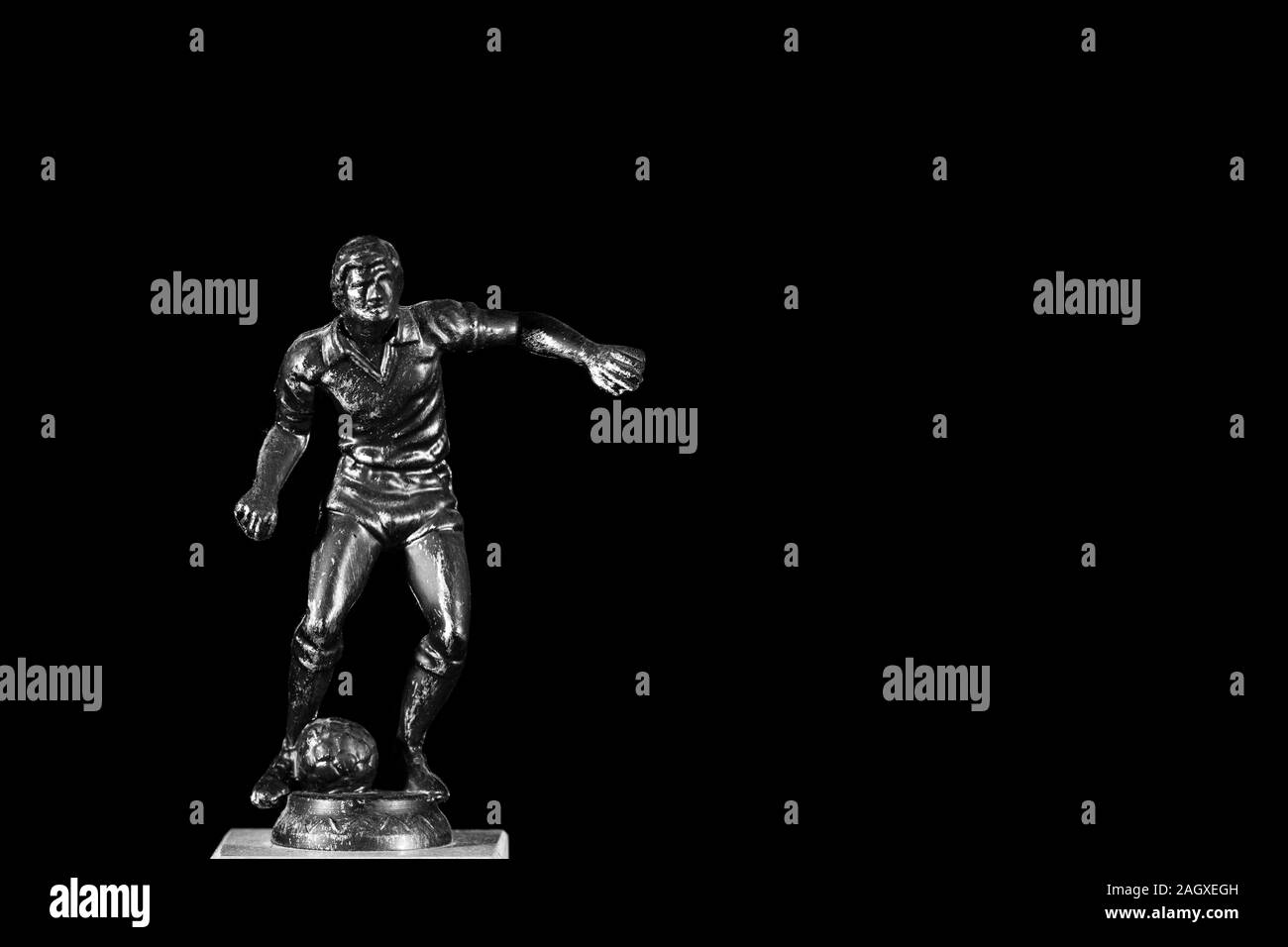 a-trophy-of-a-football-soccer-player-in-black-and-white-with-copy