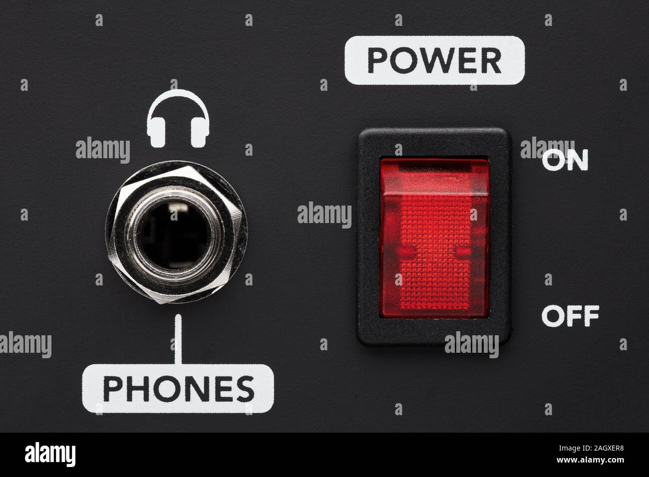 Power on and off electrical switch button and headphone input jack on a black amplifier