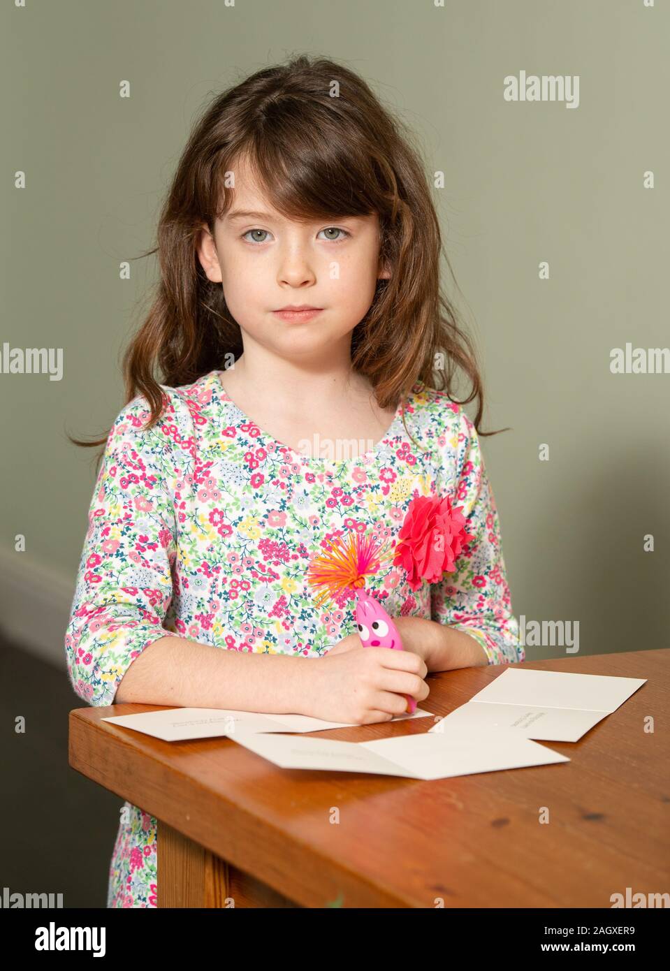 Florence Widdicombe, 6, at her home in Tooting, south London, writing in a Tesco Christmas card from the same pack as a card she found contained a message from a Chinese prisoner. The family who found a message from a Chinese prisoner in a Christmas card said they thought it was a 'prank' when they first read it. Stock Photo