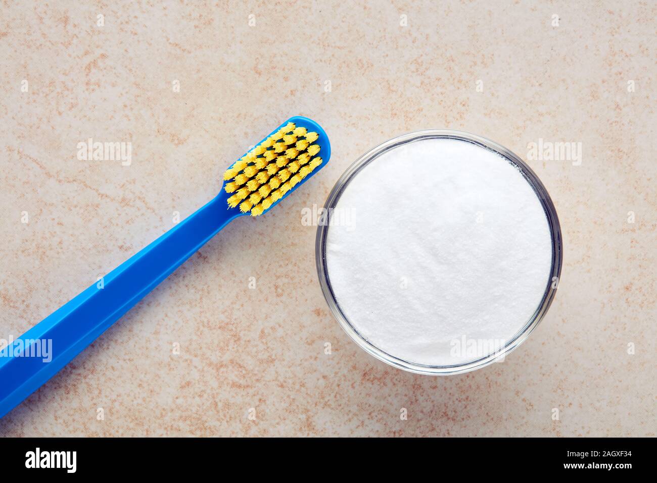 Toothbrush and baking soda in a bowl. Alternative toothpaste and dental
