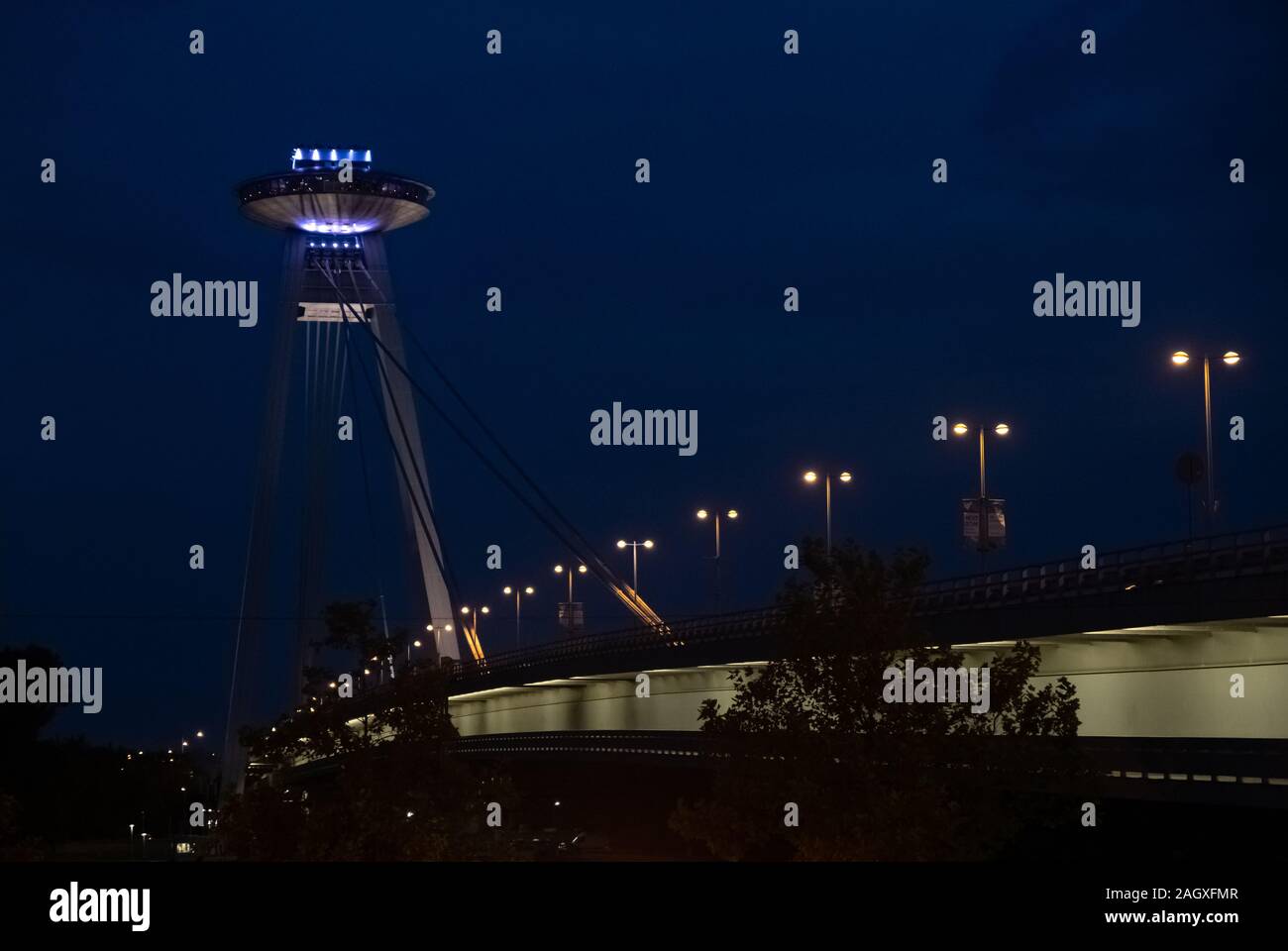 UFO Bridge over Danube River in Bratislava, Slovakia, illuminated at night Stock Photo
