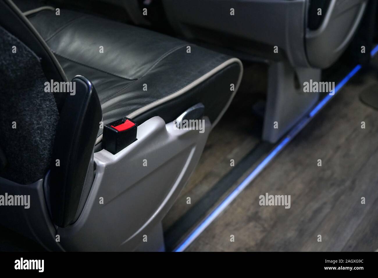 Red seatbelt clip at bus seat. Seat belts are compulsory on long distance  coaches in UK Stock Photo - Alamy