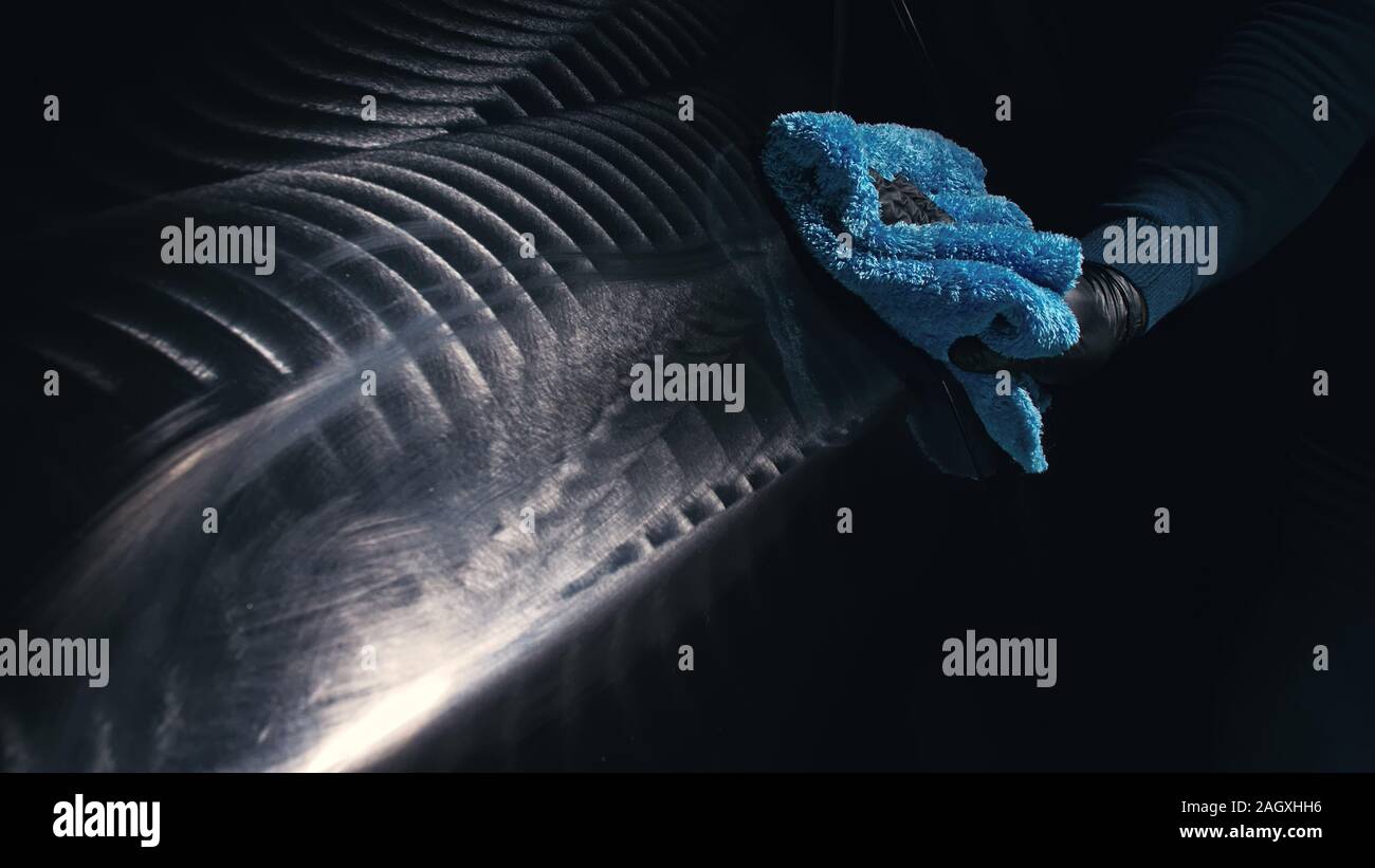 Using rag in palm of your hand, finish liquid car polish are removed