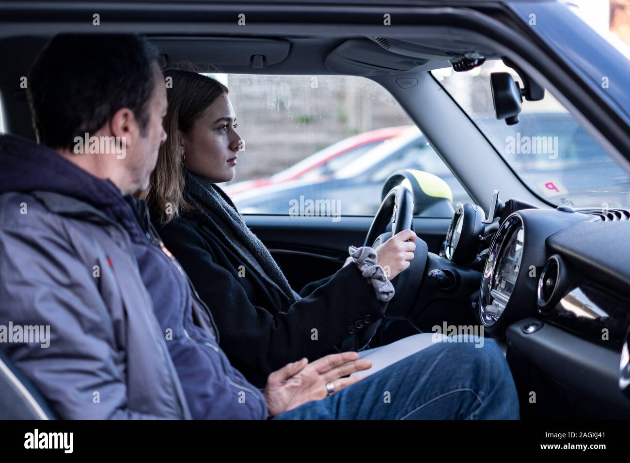 Female novice driver in a mini car in germany. Stock Photo