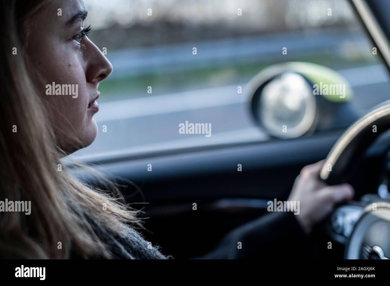 Female novice driver in a mini car in germany. Stock Photo