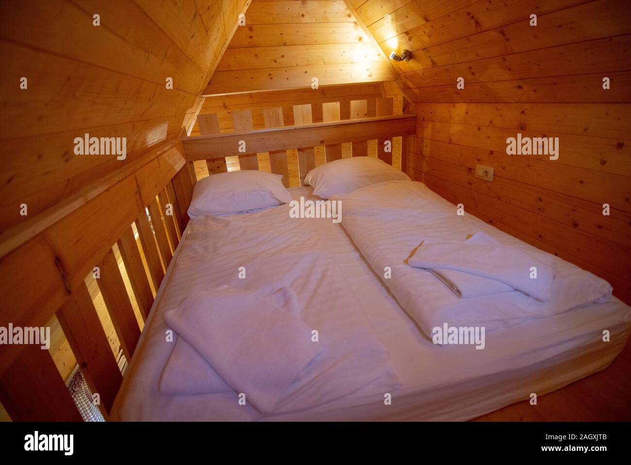Rustic little sleeping room in a wooden cottage Stock Photo