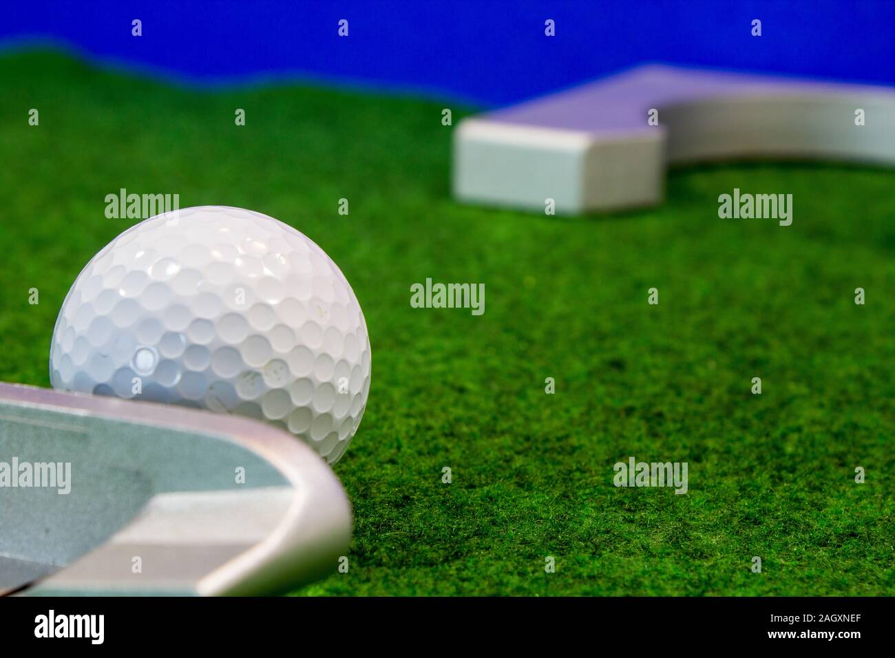 Putter, golf ball and destination for the relaxed office life Stock Photo
