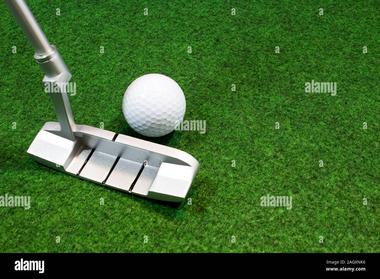 Putter, golf ball and green for the relaxed office life Stock Photo