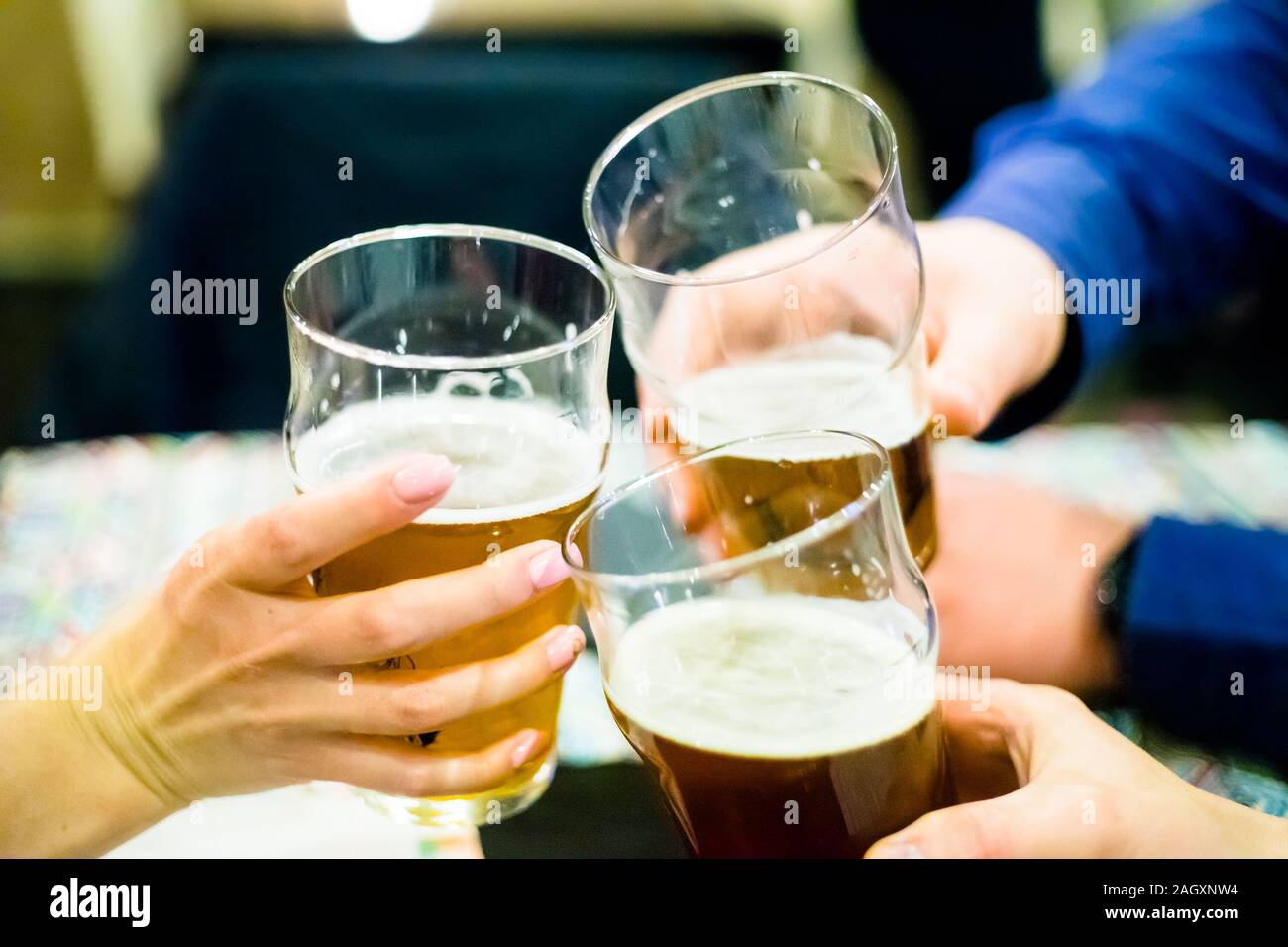 Beer Meating Evening meeting with friends. Close-up of three people drinking cold ...