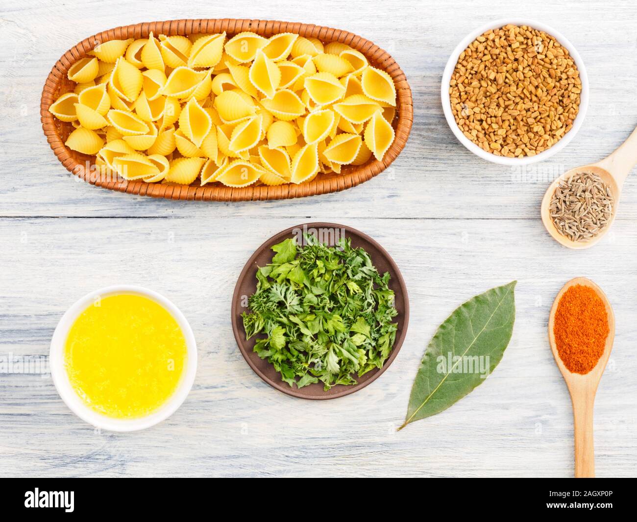 Ingredients for cooking pasta green herbs, bay leaves, fenugreek, cumin (jeera), butter (ghi