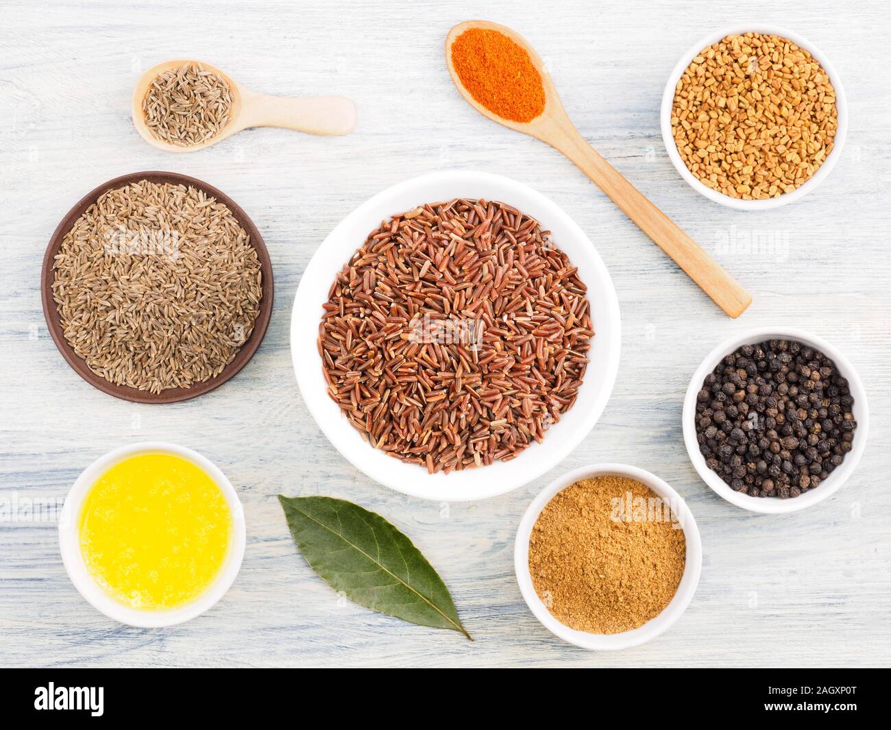 Ingredients for cooking brown rice butter, bay leaves, cumin (jeera), fenugreek, red chili