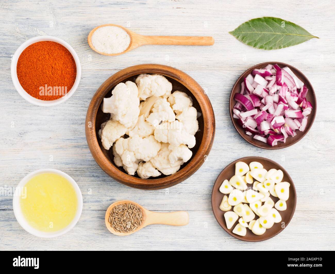 Ingredients for cooking cauliflower butter, onion, cumin (jeera), red chili pepper, salt, bay