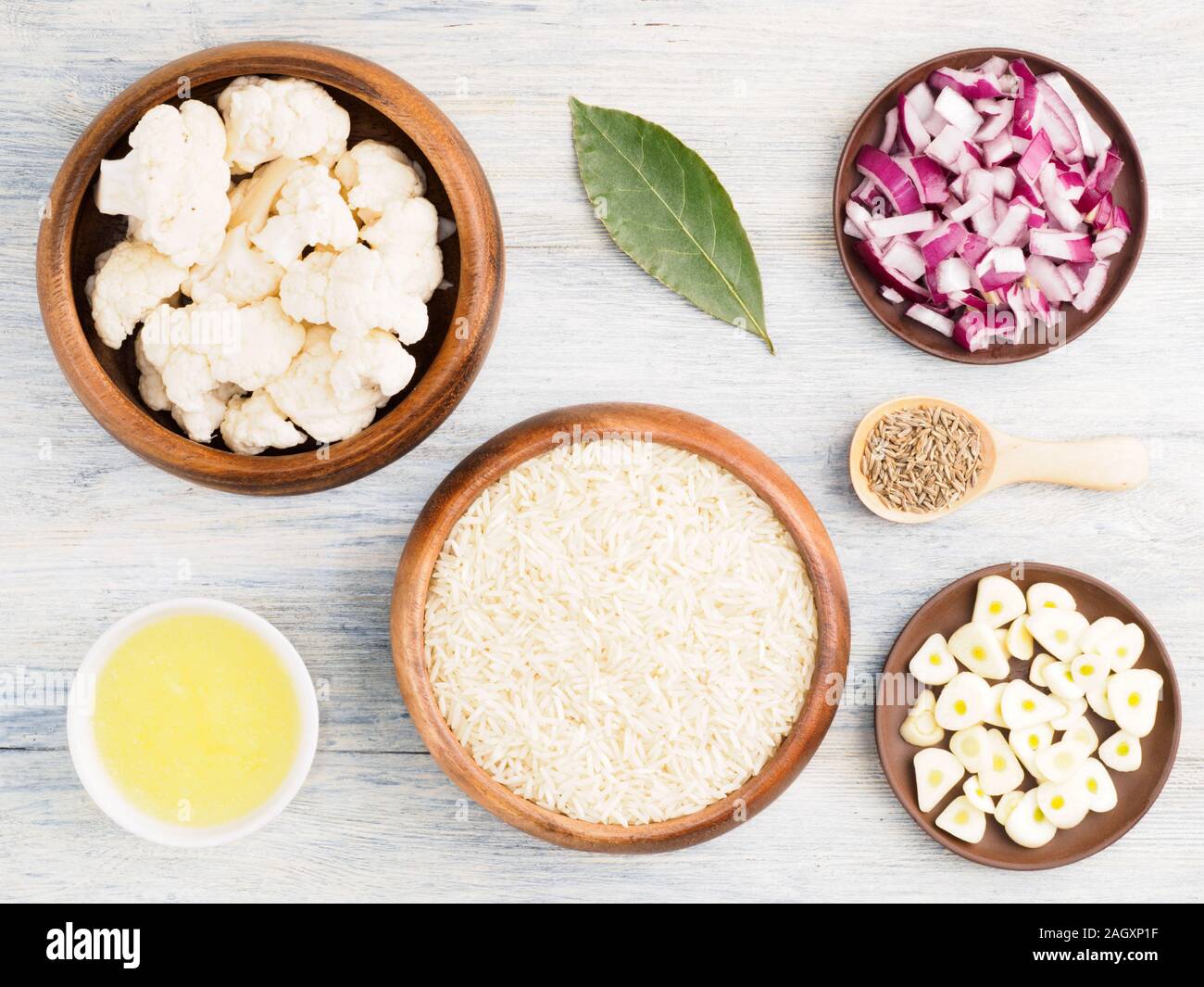 Ingredients for cooking basmati rice cauliflower, butter, red onion, bay leaves, garlic, cumin