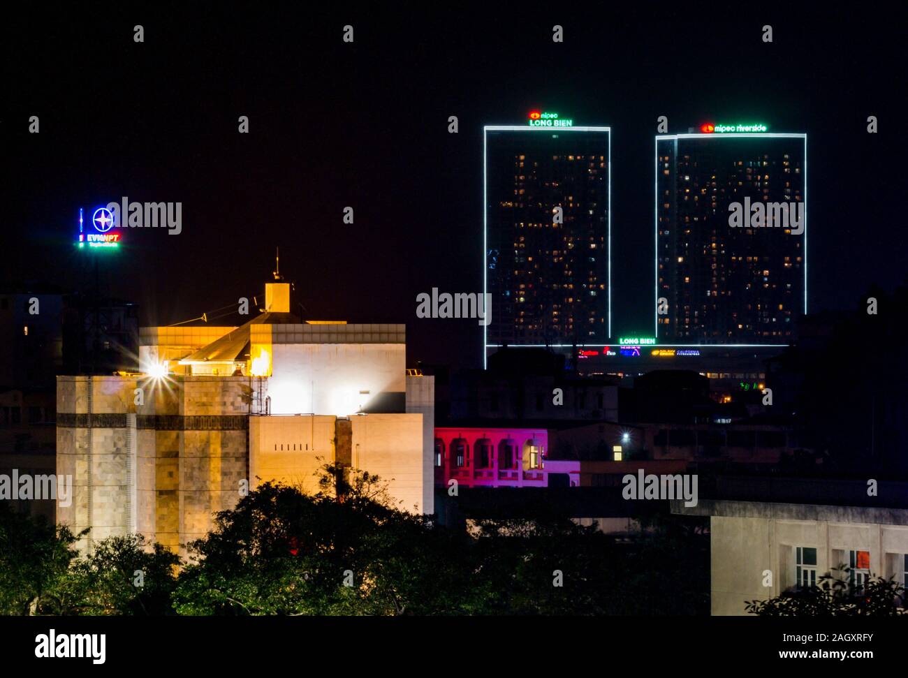 Hanoi Municipal People’s Committee building and skyscrapers lit up at night, Kiem District, Hanoi, Vietnam, Asia Stock Photo