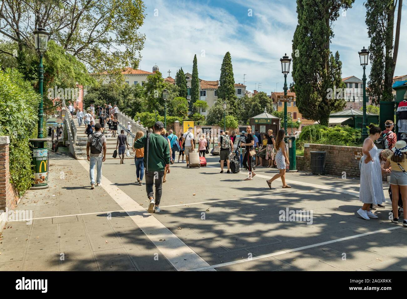 VENICE, ITALY - August 02, 2019: diverse people walking on Papadopoli Bridge in Venice Stock Photo