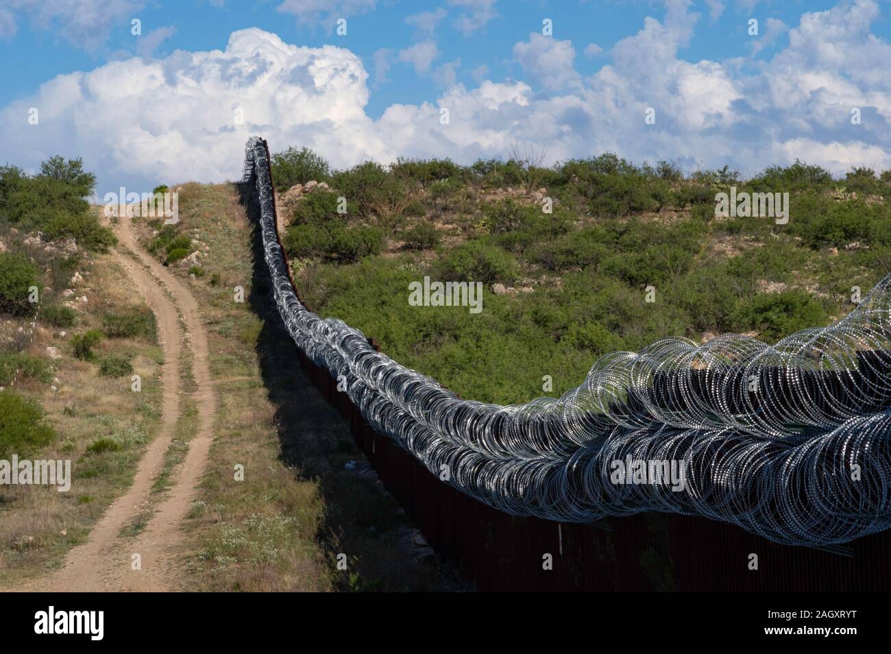 Border wall/fence with concertina wire, Sasabe, Arizona Stock Photo