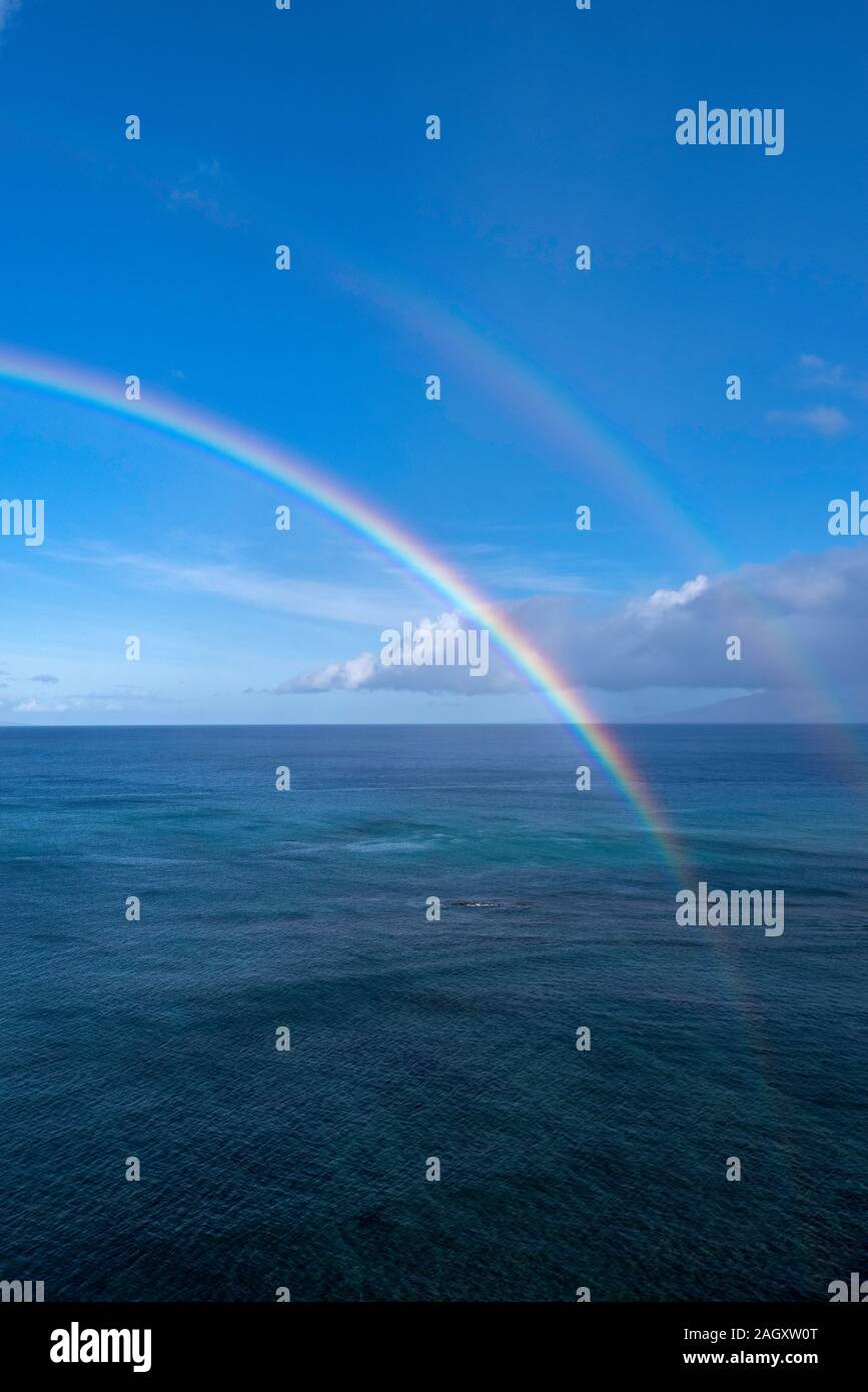 Rainbows over the Pacific from Kahana, Maui, Hawaii Stock Photo