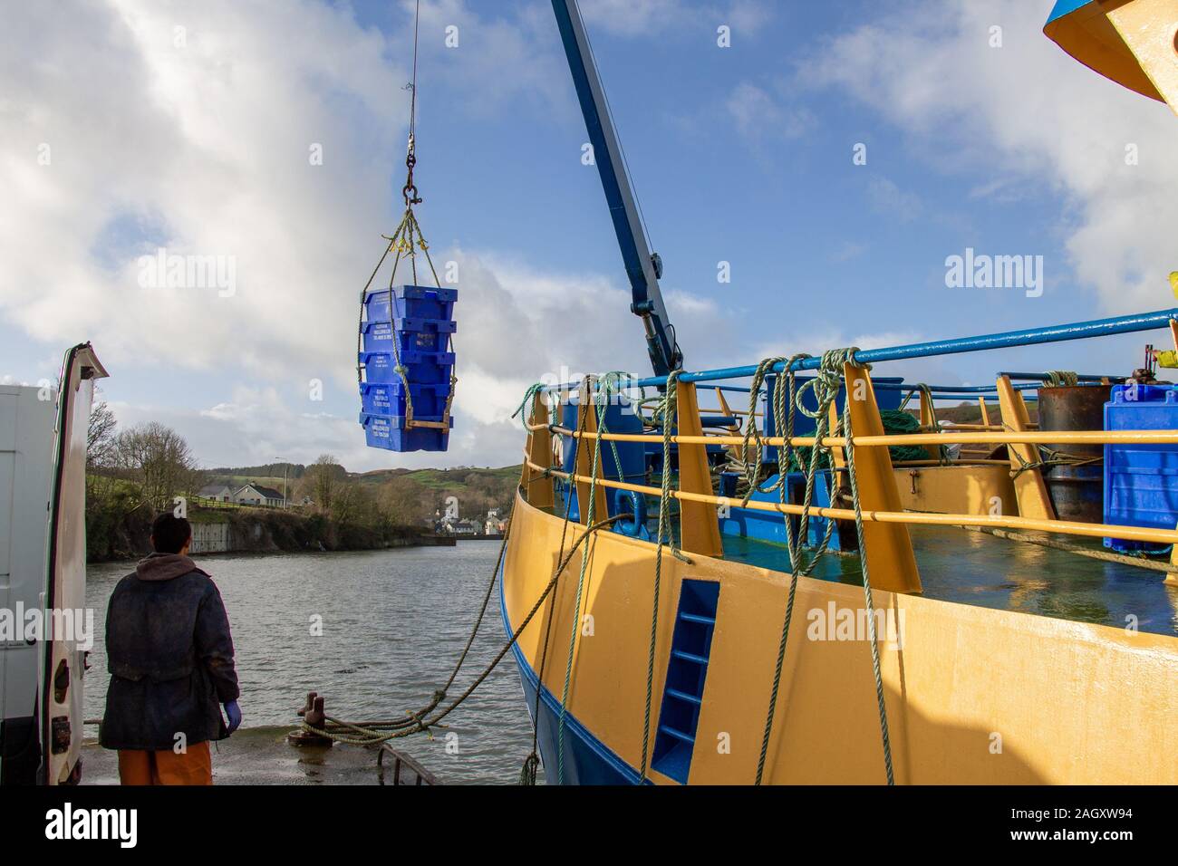Irish Trawler landing its fish catch in Union Hall harbour West Cork Ireland. Stock Photo