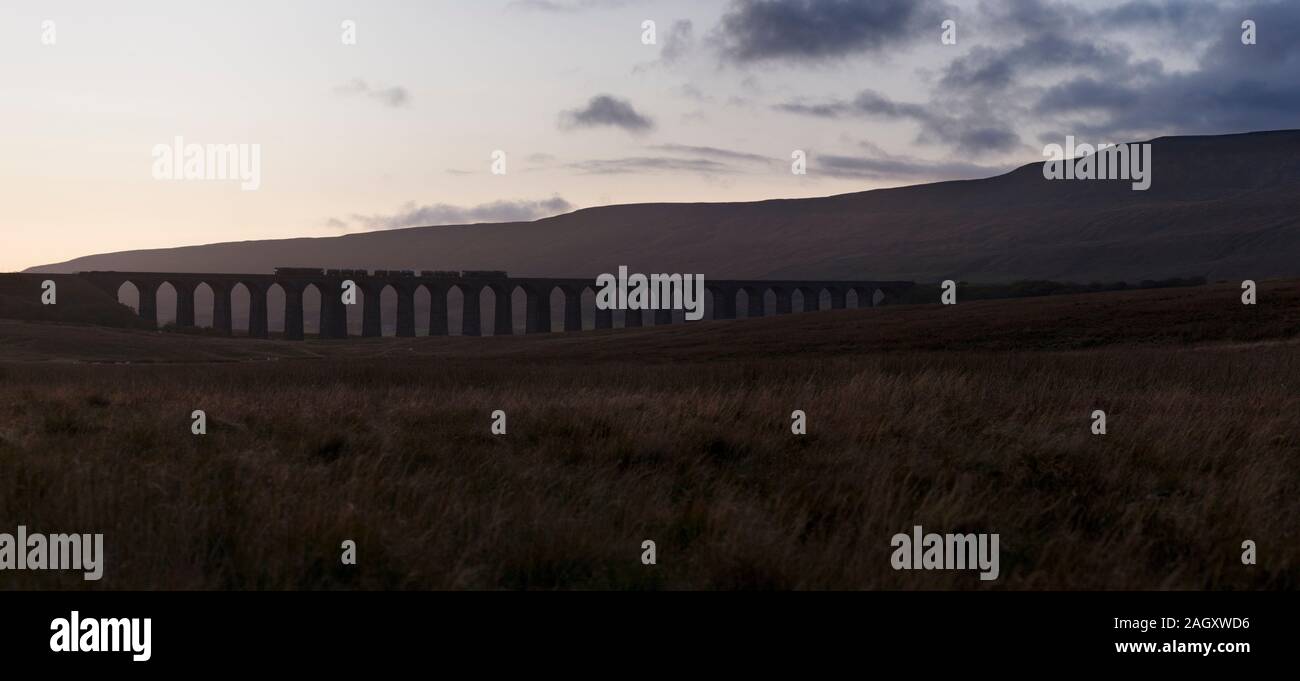 Direct Rail Services class 66 locomotives at Ribblehead viaduct with a Network rail Railhead treatment train ( RHTT ) dealing with autumn leaves Stock Photo