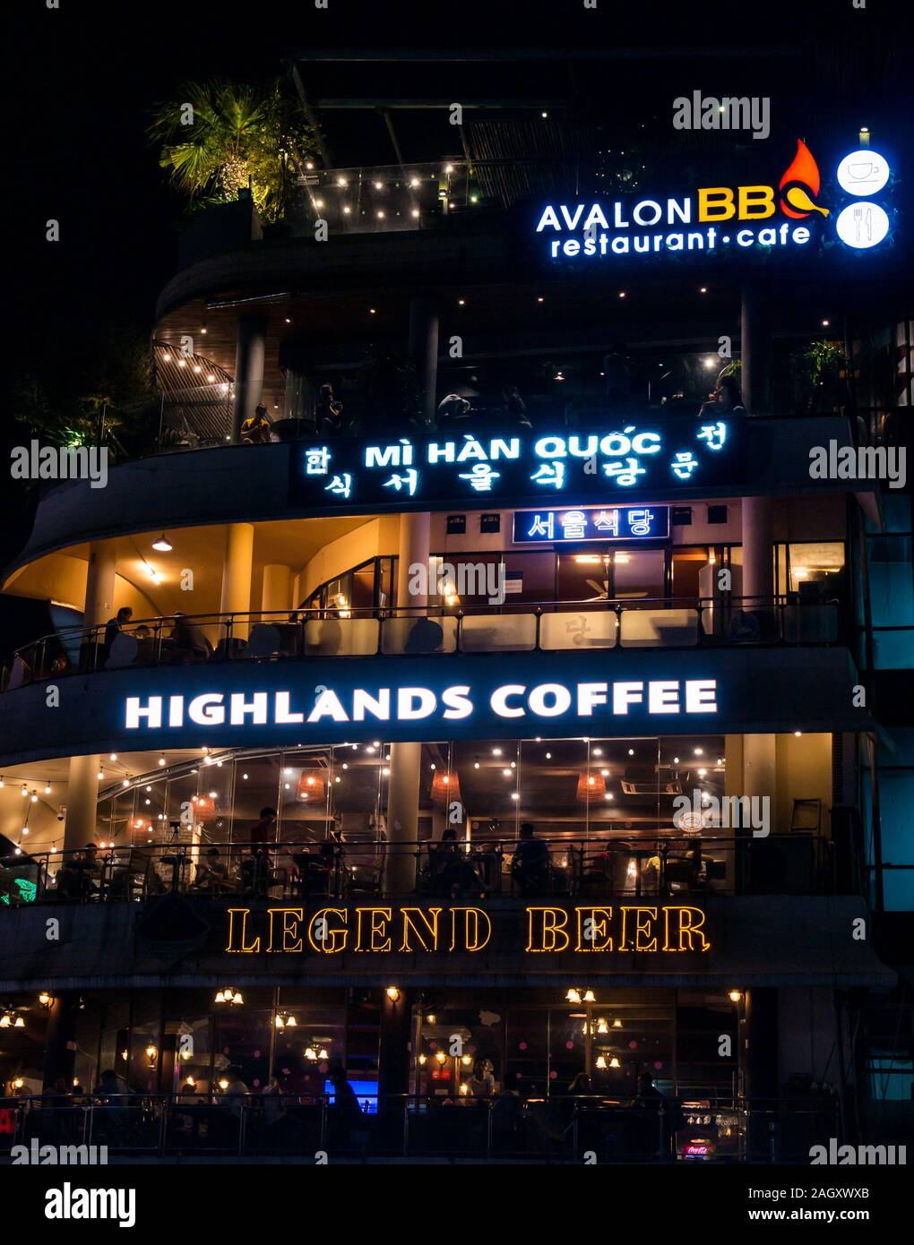 Restaurants and bars lit up at night with a Highlands Coffee and Legend Beer, Hoan Kiem District, Hanoi, Vietnam, Asia Stock Photo