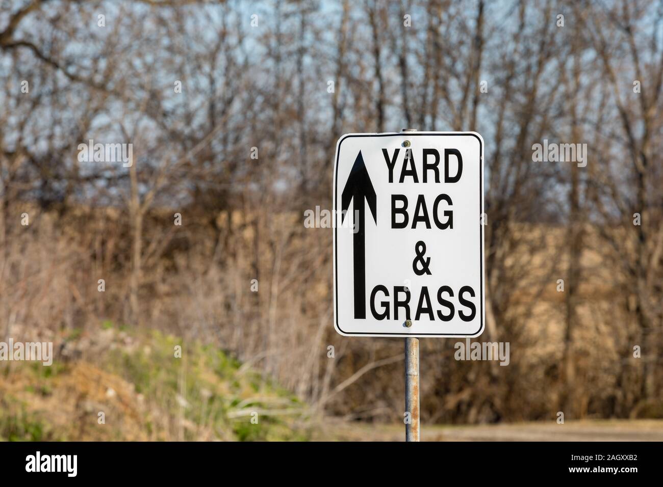 Leaf, yard bag, and grass clippings direction sign with arrow at city yard waste disposal site Stock Photo