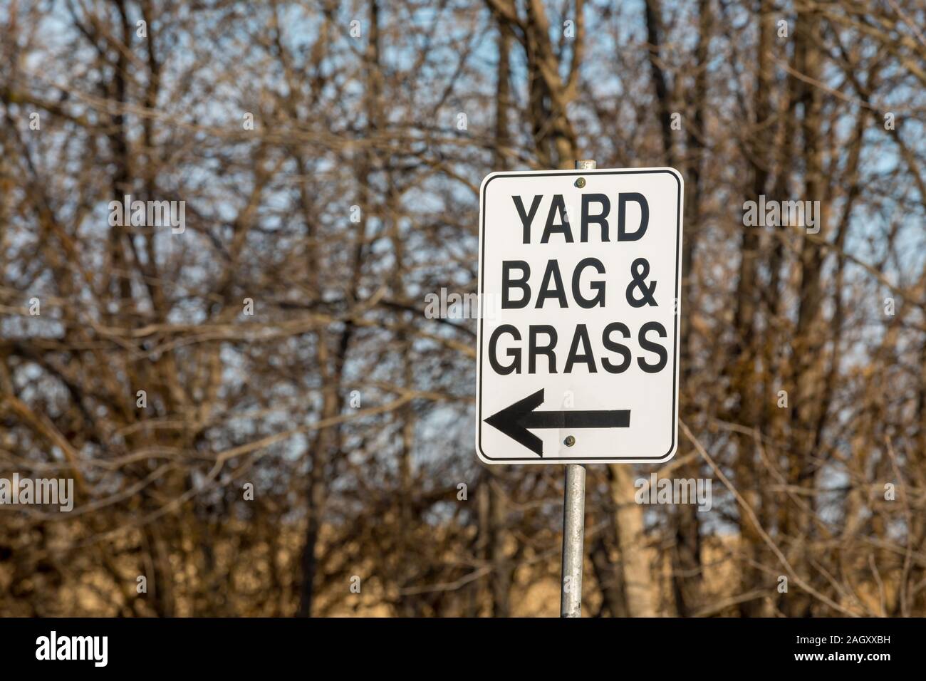 Leaf, yard bag, and grass clippings direction sign with arrow at city yard waste disposal site Stock Photo