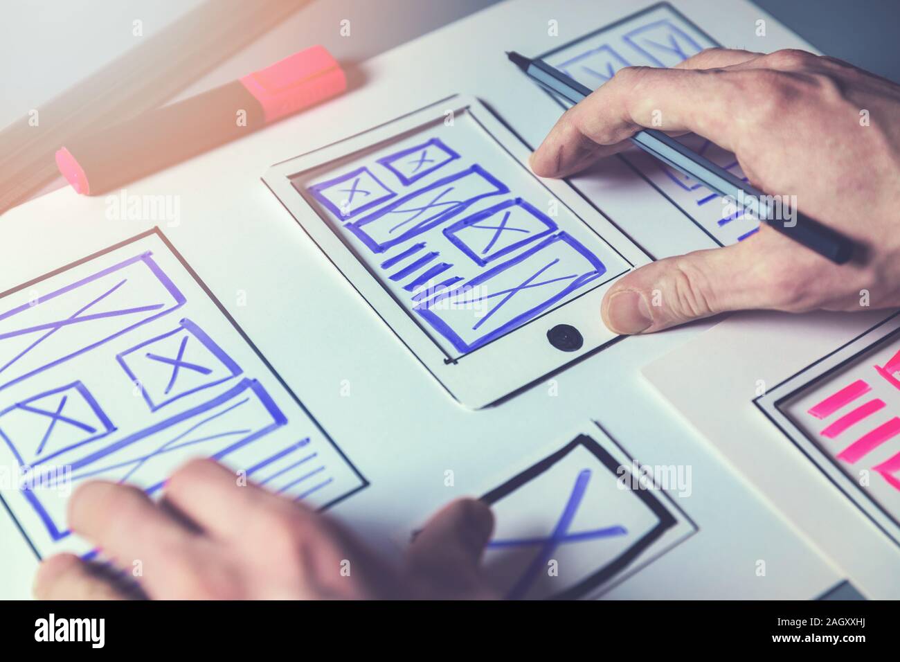 ux graphic designer sketching wireframe for mobile app and website development Stock Photo