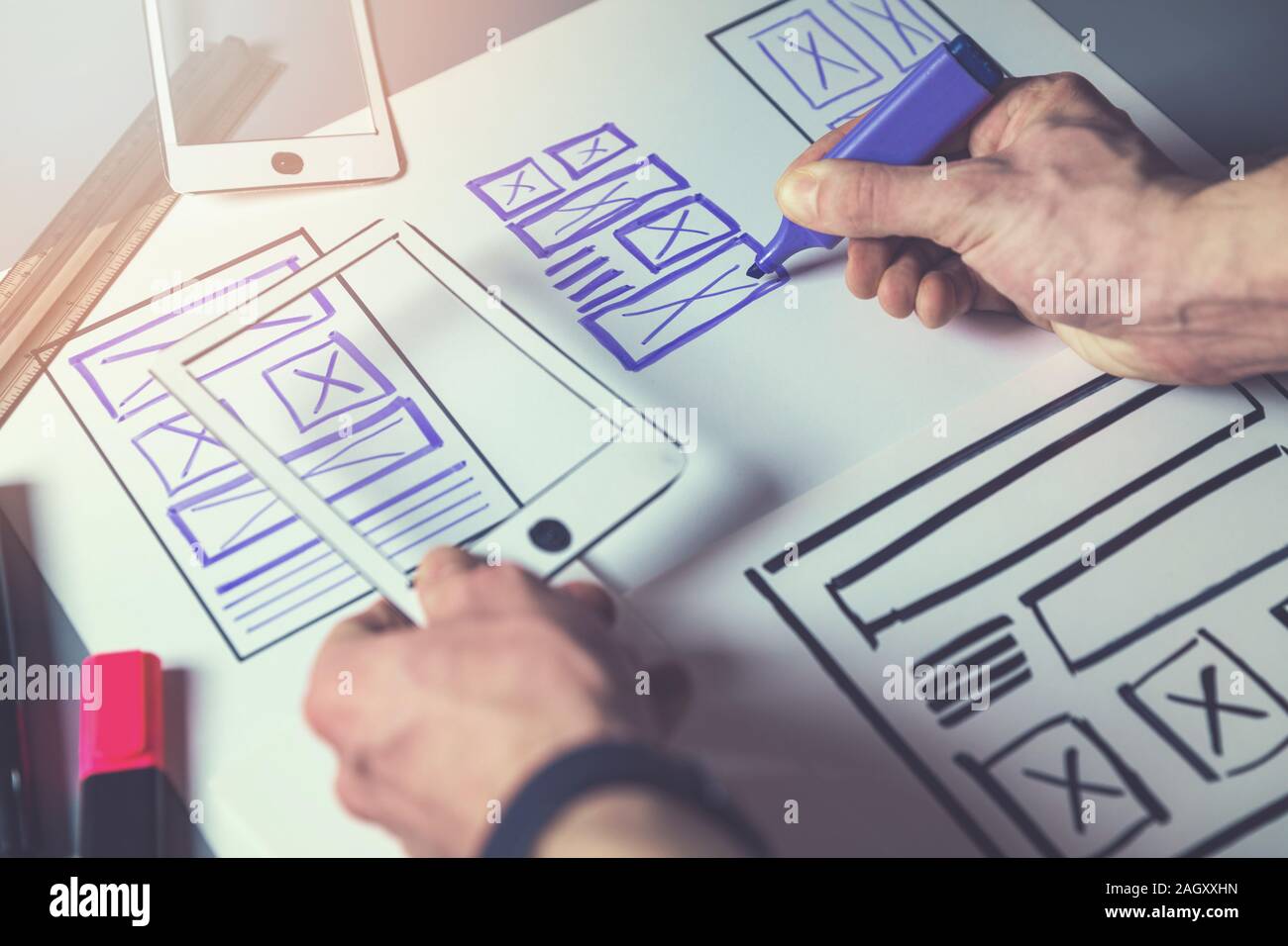 ux graphic designer sketching wireframe for mobile app and website development Stock Photo