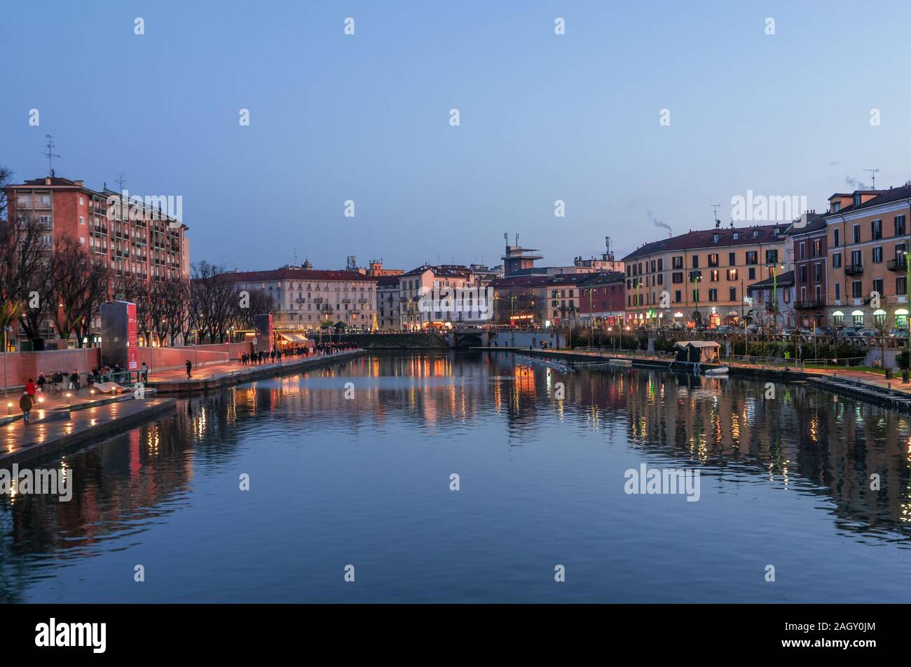 The dock (Darsena) in the tourist Navigli district while the first lights come on at sunset.Milan - Italy Stock Photo