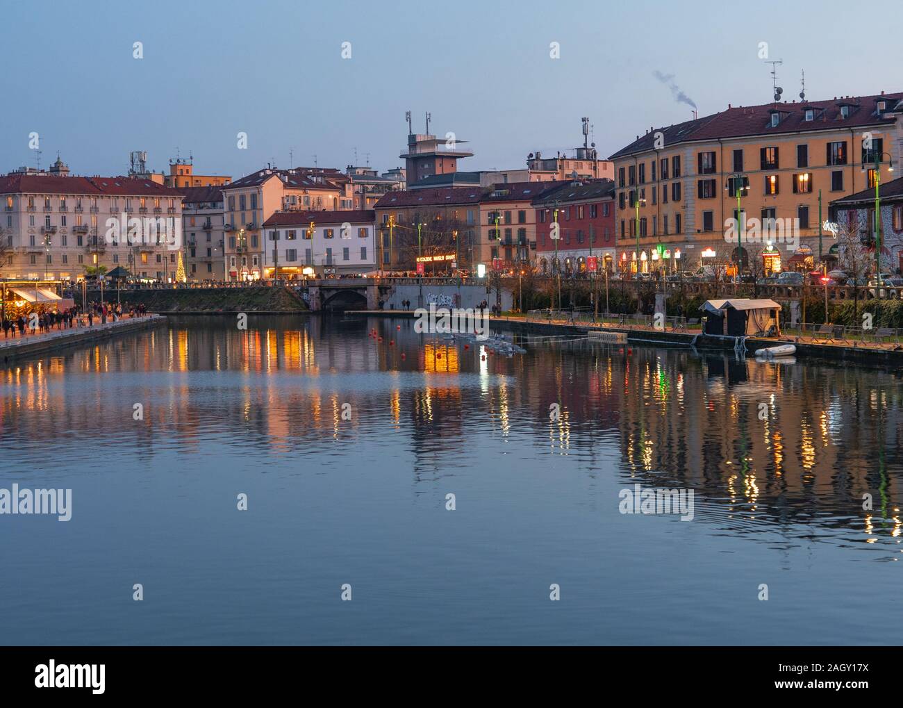 the houses of the characteristic Navigli district are reflected in the dock (Darsena) after sunset.Milan - Italy Stock Photo