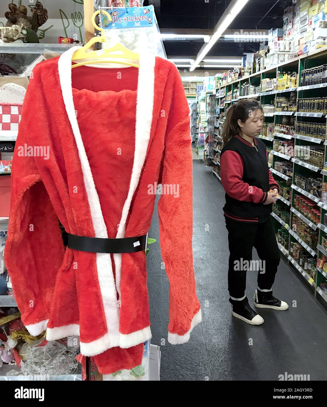 Beijing, China. 22nd Dec, 2019. A Chinese worker checks the shelves of an international supermarket, catering to the holidays with Christmas specials and gifts, in downtown Beijing on Sunday, December 22, 2019. Christmas has become a very popular holiday celebrating family, food and shopping in China. Photo by Stephen Shaver/UPI Credit: UPI/Alamy Live News Stock Photo
