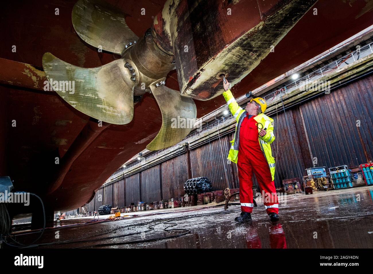Gary Fleming working on the rudder as workers at Harland and Wolff in Belfast begin work on the first ship to go through refit at the yard since the takeover by London-based energy company InfraStrata stepped in with a ??6m rescue deal that saved from yard from closure. Stock Photo