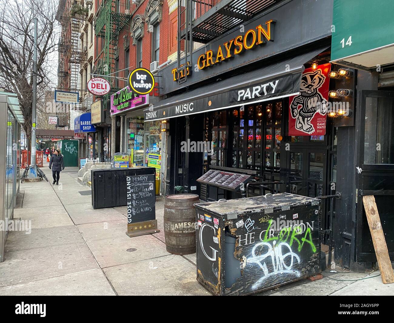 Stores, restaurants and and various services line 1st Avenue in the East Village in Manhattan. Sidewalk along 1st Ave. btwn 1st & 2nd Streets. Stock Photo