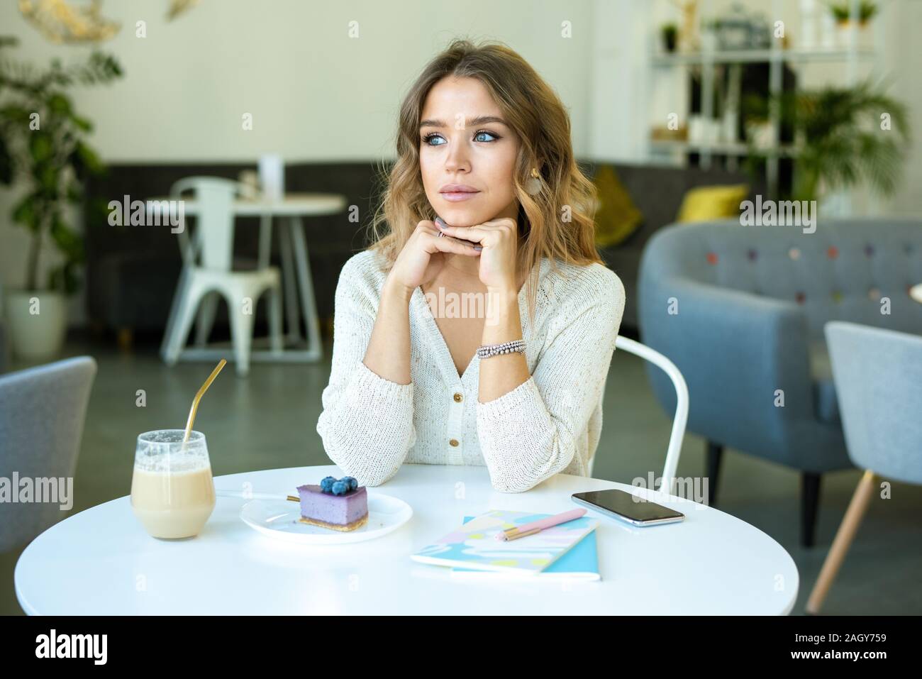 Pretty Girl With Blond Wavy Hair Thinking Of Something While