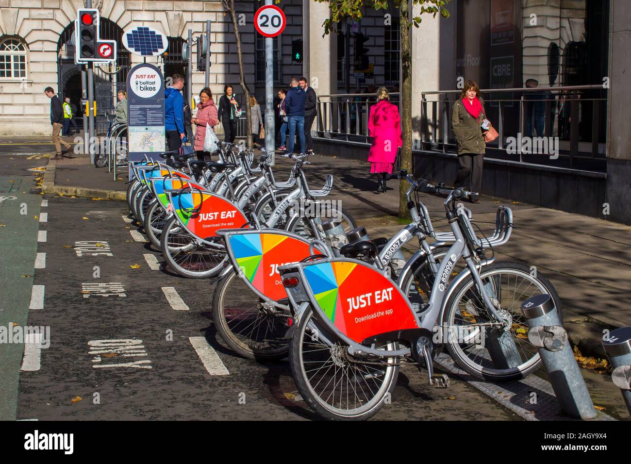 16 October 2019 A row of Bicycles with the Just Eat sponsors logo available for hire in Linenhall Street Belfast Northern Ireland Stock Photo
